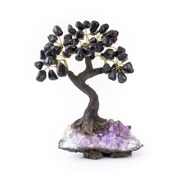 Medium black onyx bonsai tree with tumbled black onyx leaves on raw amethyst base.